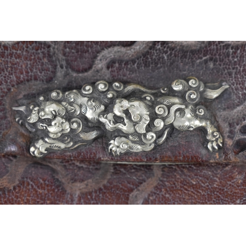 23 - A Japanese Meiji period tobacco sagemono (pouch) made from leather, with white metal foo dogs to the... 