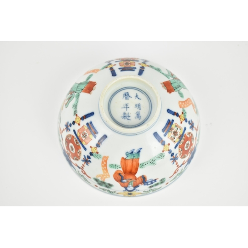 24 - A Chinese wucai porcelain 'immortals' bowl, with doucai decoration of underglazed blue and applied e... 