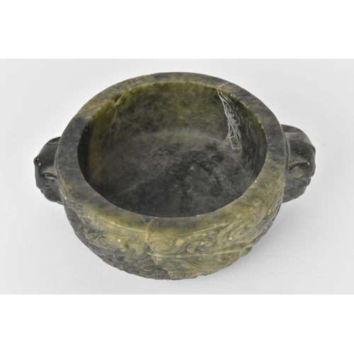 26 - A Chinese soapstone censer, late 19th/20th century, of circular form with mythical beast handles eit... 