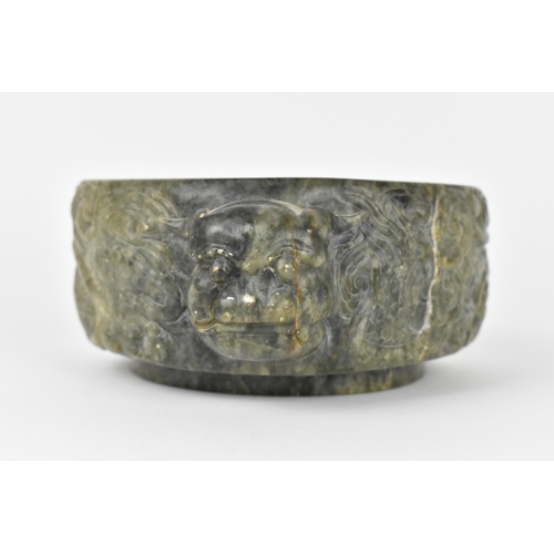 26 - A Chinese soapstone censer, late 19th/20th century, of circular form with mythical beast handles eit... 