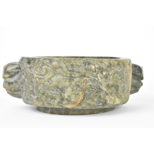 26 - A Chinese soapstone censer, late 19th/20th century, of circular form with mythical beast handles eit... 