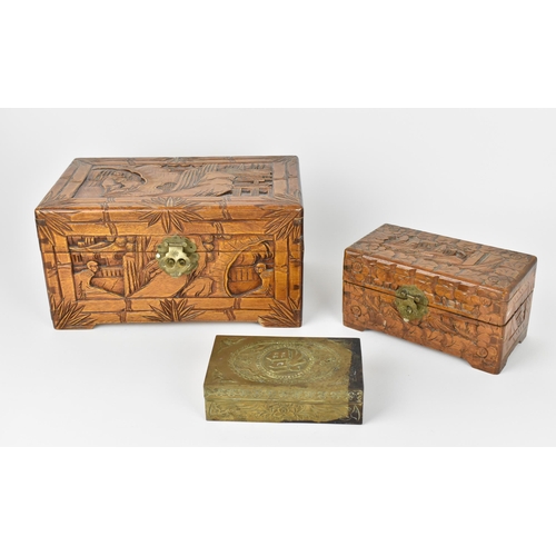 42 - Two Chinese carved camphor wood boxes, the larger one with carved landscapes and figures in bamboo s... 