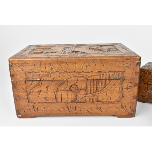 42 - Two Chinese carved camphor wood boxes, the larger one with carved landscapes and figures in bamboo s... 