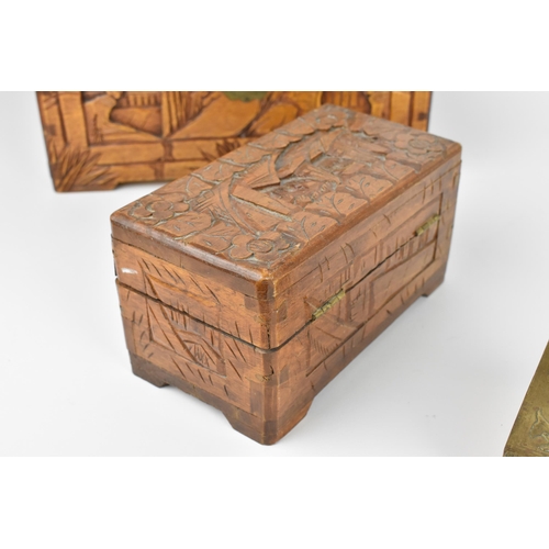 42 - Two Chinese carved camphor wood boxes, the larger one with carved landscapes and figures in bamboo s... 