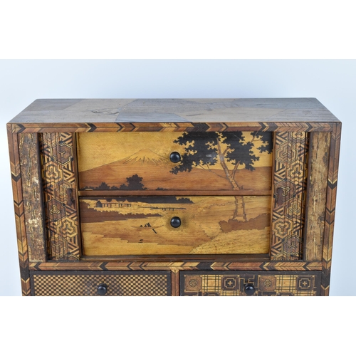 43 - A Japanese Meiji period miniature tansu parquetry cabinet, with tambour sliding front doors revealin... 