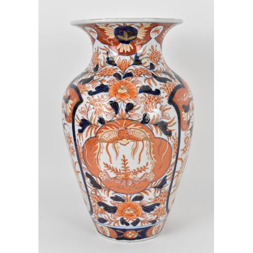 44 - A Japanese Imari porcelain baluster vase, with everted rim, the body decorated with two large panels... 