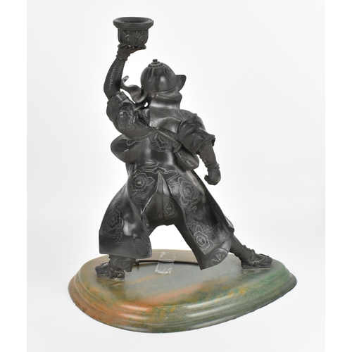 50 - A composite or resin candlestick model of a samurai warrior, with brown patina effect, mounted on a ... 