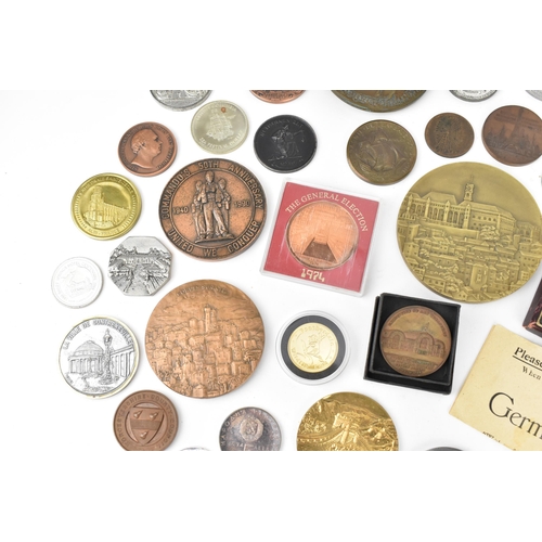 116 - A collection of assorted commemorative medals to include a medal commemorating the opening of St Nic... 