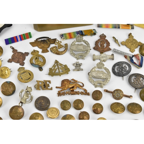 142 - First World War and later cap badges, medal bars and mixed buttons to include Royal Tank Corps, The ... 