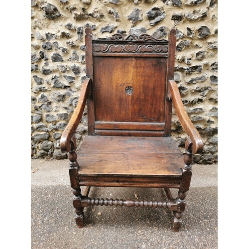 266 - An 18th century carved oak wainscott armchair, the back panel carved with central patera, supported ... 