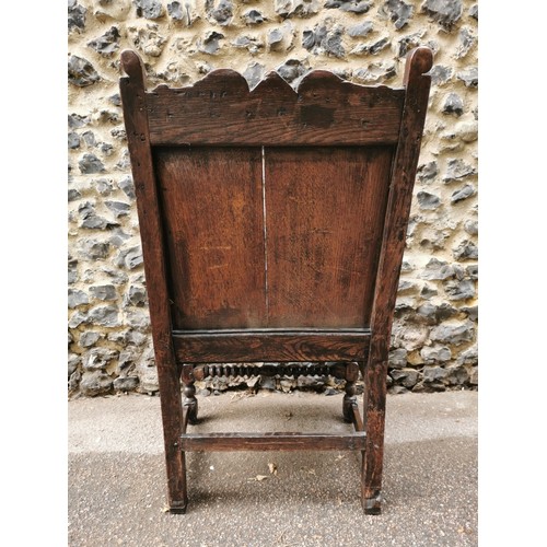 266 - An 18th century carved oak wainscott armchair, the back panel carved with central patera, supported ... 