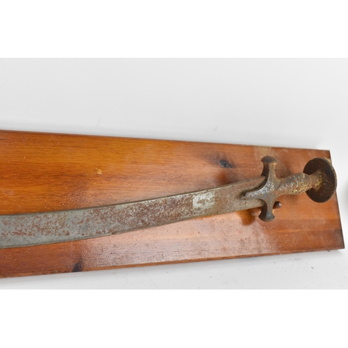 160 - An early 19th century Indian Tulwar having a 70cm curved, single edge blade, steel decorated cross g... 