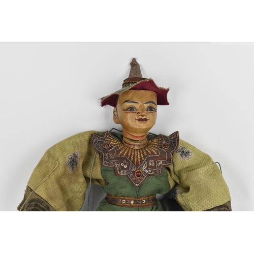 87 - An early 20th century Thai or Burmese puppet, with gilt thread and sequin embellished clothing, and ... 