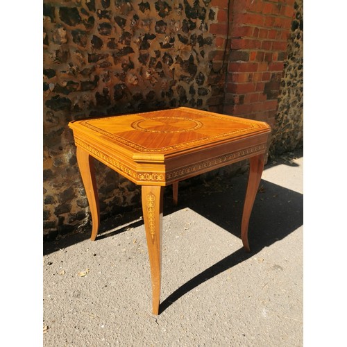 226 - An Italian marquetry games table, inlaid to the top with floral wreath, the inside with central roul... 