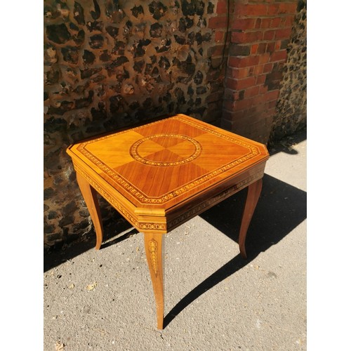 226 - An Italian marquetry games table, inlaid to the top with floral wreath, the inside with central roul... 