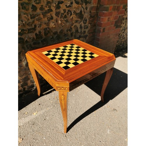 226 - An Italian marquetry games table, inlaid to the top with floral wreath, the inside with central roul... 