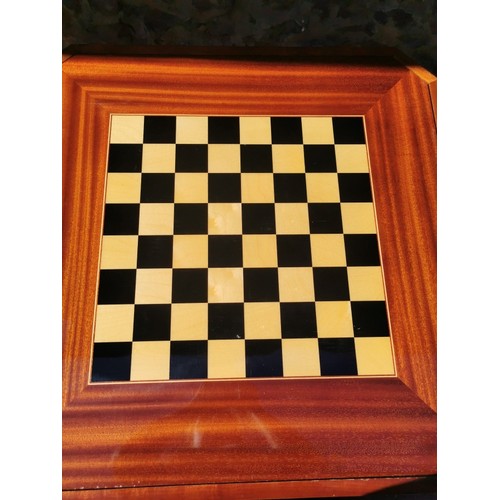 226 - An Italian marquetry games table, inlaid to the top with floral wreath, the inside with central roul... 