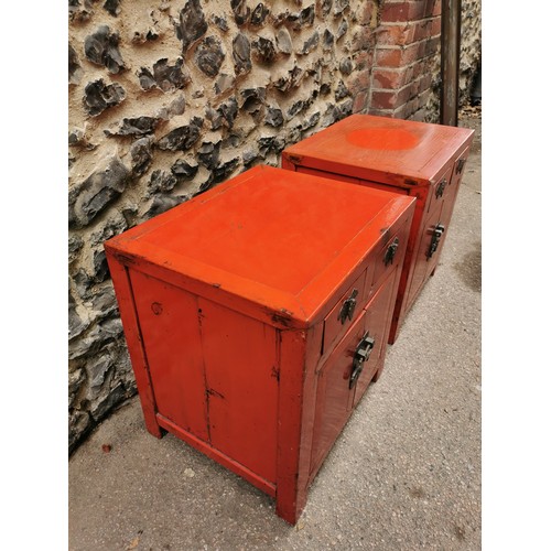 66 - A pair of Chinese red lacquer bedside cabinets, early 20th century, of square form with two small to... 