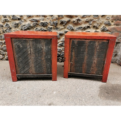 66 - A pair of Chinese red lacquer bedside cabinets, early 20th century, of square form with two small to... 