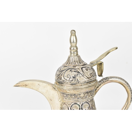 191 - A Middle-Eastern white metal Dallah coffee pot, designed with embossed foliate friezes throughout, h... 