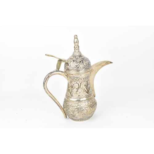 191 - A Middle-Eastern white metal Dallah coffee pot, designed with embossed foliate friezes throughout, h... 