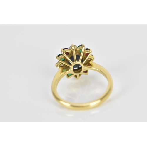 238 - An 18ct yellow gold, diamond, emerald, and ruby dress ring, with central twelve claw set oval cut da... 