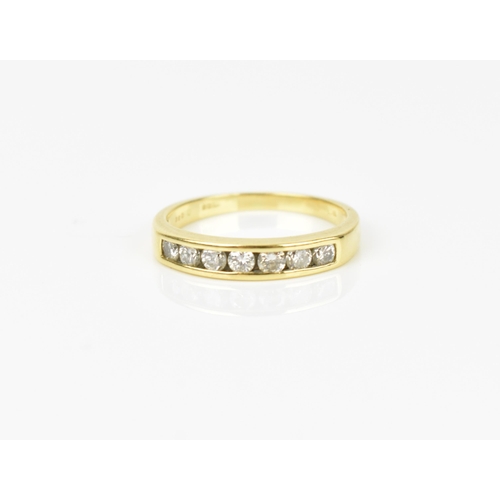 240 - An 18ct yellow gold and diamond half eternity ring, with seven channel set round brilliant cut diamo... 