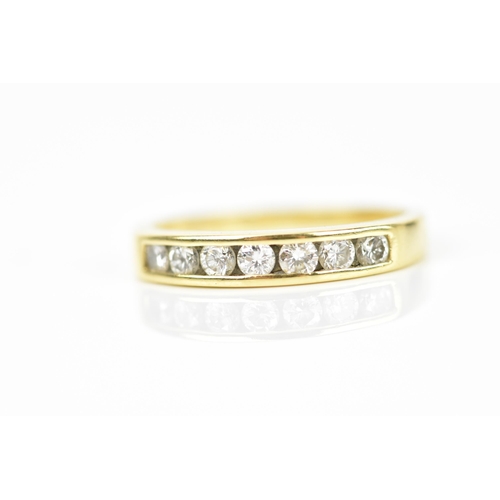 240 - An 18ct yellow gold and diamond half eternity ring, with seven channel set round brilliant cut diamo... 