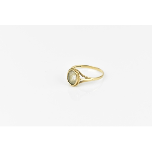 241 - A 9ct yellow gold and clear stone dress ring, with central rub over set oval cut stone, possibly fad... 