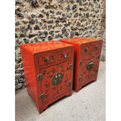 62 - A pair of Chinese red lacquer bedside cabinets, early 20th century, each with two small drawers abov... 