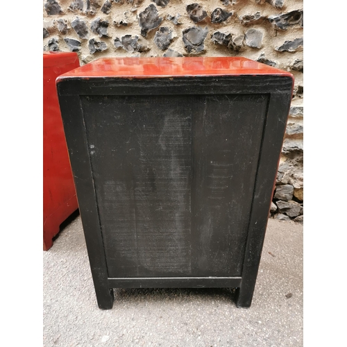 62 - A pair of Chinese red lacquer bedside cabinets, early 20th century, each with two small drawers abov... 