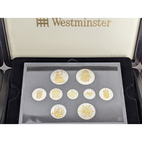 100A - A collection of three Westminster coin sets to include The House of Windsor crown set of three silve... 