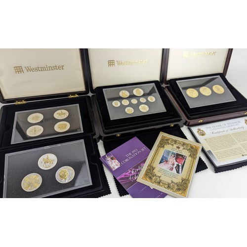 100A - A collection of three Westminster coin sets to include The House of Windsor crown set of three silve... 