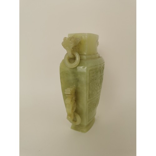 73 - A Chinese celadon jade taotie vase, of tapered form with dragon handles and hanging hoops, the front... 