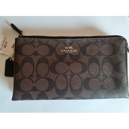 12 - Coach-A signature PVC double zip wallet  in dark brown minus detachable wrist strap, having a black ... 