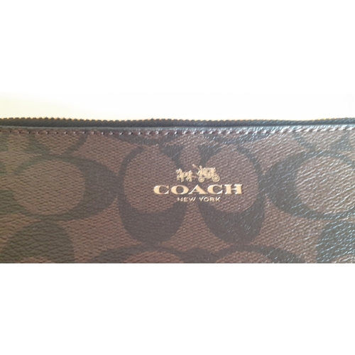 12 - Coach-A signature PVC double zip wallet  in dark brown minus detachable wrist strap, having a black ... 