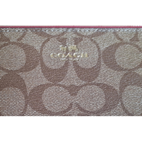 13 - Coach-A signature PVC double zip wallet  in light brown and gold with pink detachable wrist strap, z... 