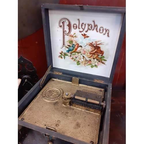 132 - A polyphon music box and 12 discs. Location:1:3