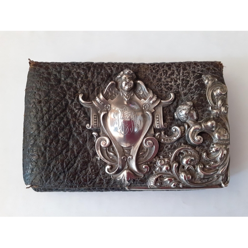 17 - A 1920's German silver and black leather purse, A/F having a traditional German shield design to the... 