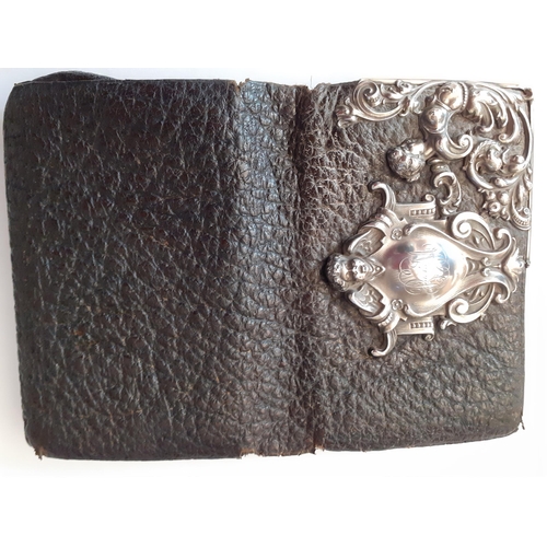 17 - A 1920's German silver and black leather purse, A/F having a traditional German shield design to the... 