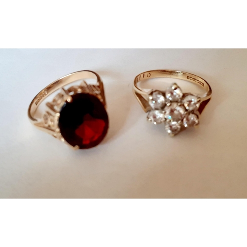 119 - Two 9ct gold dress rings, one set with white cabochons and the other with a large garnet, total weig... 