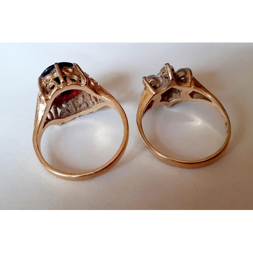 119 - Two 9ct gold dress rings, one set with white cabochons and the other with a large garnet, total weig... 