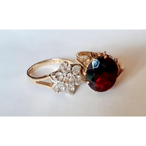 119 - Two 9ct gold dress rings, one set with white cabochons and the other with a large garnet, total weig... 