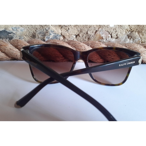 22 - Ralph Lauren-A pair of ladies brown tortoiseshell effect sunglasses with gold tone ornate metal inla... 