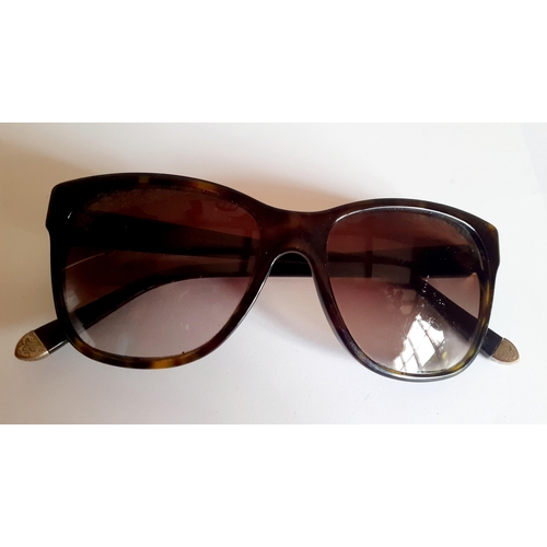 22 - Ralph Lauren-A pair of ladies brown tortoiseshell effect sunglasses with gold tone ornate metal inla... 