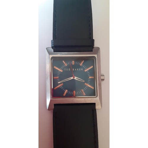 23 - Ted Baker-A modern gents watch, having a square silver toned dial with turquoise coloured background... 