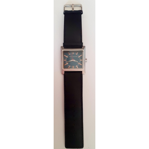 23 - Ted Baker-A modern gents watch, having a square silver toned dial with turquoise coloured background... 