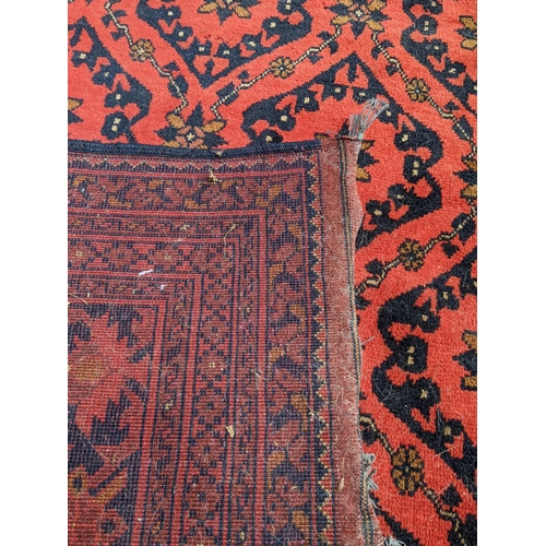 239 - A late 20th century Persian design floral rug in browns and red 
Location: G