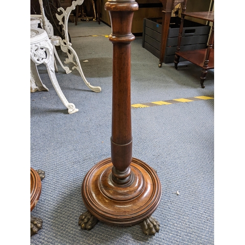 213 - A pair of William IV rosewood poles screens having flower brass finials, turned columns and raised o... 