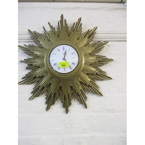 164 - A Metamee quartz Sunburst clock, a gilt framed wall mirror, bevelled glass and fabric tassels, and a... 